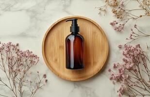 Rustic display of essential oil bottle on natural wooden plate with dried herbs and flowers photo