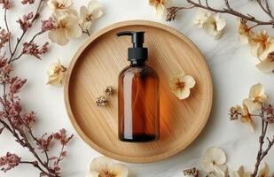 Rustic display of essential oil bottle on natural wooden plate with dried herbs and flowers photo