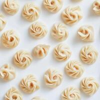 Dumplings arranged neatly on a white surface for culinary display and preparation in a kitchen setting photo