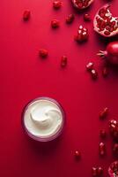 Creamy dessert topped with pomegranate seeds on a vibrant red backdrop photo