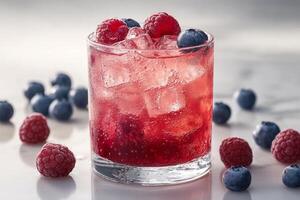 Refreshing berry beverage with ice and fresh fruits in a glass photo