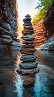 Stones stacked carefully in a tranquil stream surrounded by lush greenery and tall trees photo