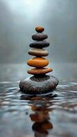 Stones stacked carefully in a tranquil stream surrounded by lush greenery and tall trees photo