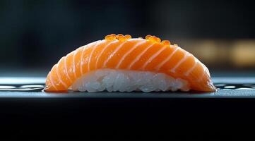 Slices of salmon and white fish sushi served on a dark stone plate with garnish photo