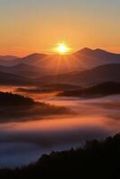 Sunrise over misty mountains with golden hues illuminating the landscape photo