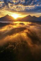 Sunrise over misty mountains with golden hues illuminating the landscape photo