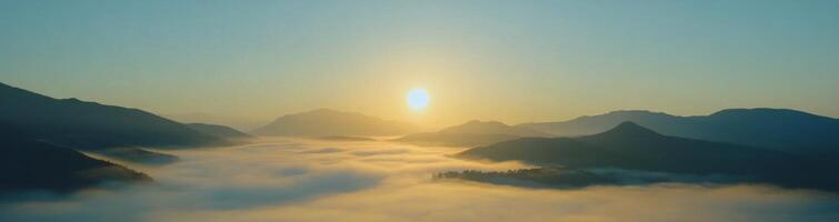 Paragliding above mountains at sunrise with clouds beneath in a breathtaking landscape photo