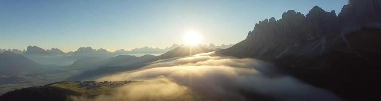 Paragliding above mountains at sunrise with clouds beneath in a breathtaking landscape photo