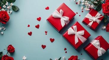Colorful gift boxes with roses and hearts on a blue background for a special occasion photo