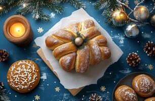 Festive dessert presentation with wrapped bread on blue background surrounded by decorations photo