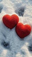 Red hearts resting on snow create a cozy winter atmosphere in a chilly landscape photo