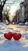 Red hearts resting on snow create a cozy winter atmosphere in a chilly landscape photo