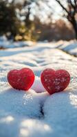 Red hearts resting on snow create a cozy winter atmosphere in a chilly landscape photo