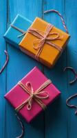 Colorful wrapped gifts on a blue background with bokeh highlights for festive occasions photo