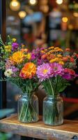 Colorful fresh flower arrangements in jars displayed at a floral shop photo