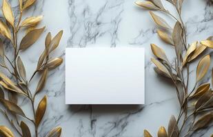 Blank card surrounded by olive branches on marble surface in natural light photo
