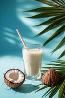 Refreshing coconut drink served with straws and garnished with green leaf photo