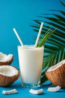 Refreshing coconut drink served with straws and garnished with green leaf photo