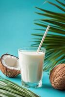 Refreshing coconut drink served with straws and garnished with green leaf photo