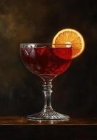 Elegant red cocktail with a slice of orange garnish in a glass photo