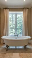 Elegant bathroom with a freestanding tub and scenic window view in a serene setting photo