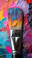 Vibrant brush resting on colorful paint palette showcasing artistic creativity and texture photo