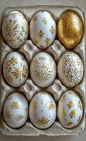 Decorative eggs arranged in an egg carton with intricate patterns and gold accents photo