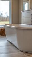 Elegant bathroom with a freestanding tub and scenic window view in a serene setting photo