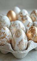 Decorative eggs arranged in an egg carton with intricate patterns and gold accents photo