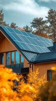 Beautiful stone house with solar panels and vibrant flower garden in sunny weather photo