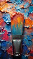 Vibrant brush resting on colorful paint palette showcasing artistic creativity and texture photo