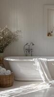 Elegant freestanding bathtub in bright bathroom with large windows and natural decor photo