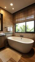 Elegant bathroom with a freestanding tub and scenic window view in a serene setting photo