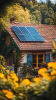 Beautiful stone house with solar panels and vibrant flower garden in sunny weather photo