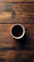Coffee cup with brown liquid and coffee beans on wooden surface at cozy cafe photo