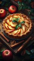 Delicious apple pie surrounded by fresh apples and cinnamon sticks on a wooden table photo