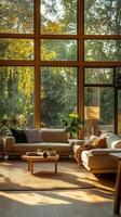 Cozy modern living room with large windows in a serene setting during golden hour photo