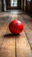 Red bowling ball rolls down a vintage wooden lane in a spacious bowling alley photo