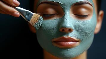 Relaxing facial treatment featuring a woman applying a green clay mask at a spa photo