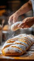 Baker dusts fresh bread rolls with flour in a rustic kitchen setting photo