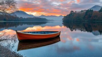 Serene sunset over calm waters with a single boat floating in pastel hues photo