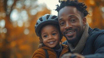 Joyful father and son enjoying a sunny day outdoors in autumn with a bike helmet photo