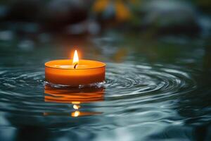 Floating candle illuminates rippling water during a serene evening setting photo