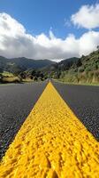 Yellow line on a quiet street captured under clear blue sky during daytime hours photo