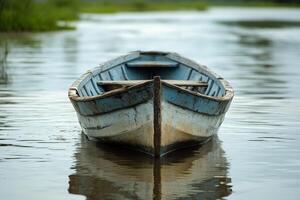 Calm boat resting on tranquil lake surrounded by lush green trees photo