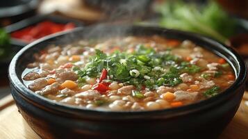 Rich, aromatic stew bubbling in a black pot over an open flame during a cozy gathering photo
