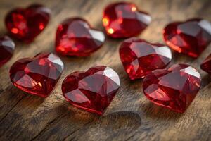 Red heart-shaped gems scattered on a rustic wooden surface creating a romantic ambiance photo