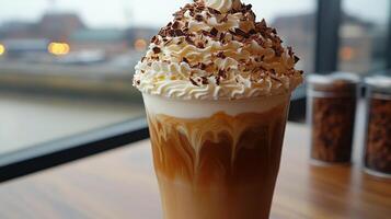 Delicious hot chocolate topped with whipped cream and chocolate shavings served in a cozy caf photo