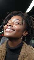 Woman with curly hair and freckles smiling brightly in a warm atmosphere photo