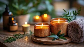 Relaxing spa setting with candles, essential oil, and towels on a wooden surface at evening time photo